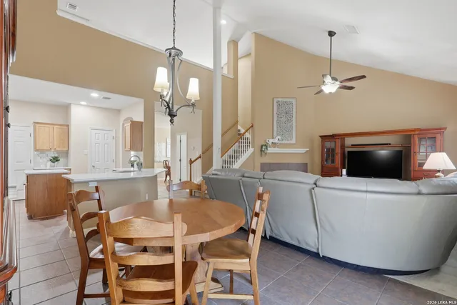 a view of a dining room with furniture and a chandelier