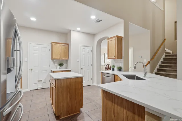 a kitchen with a stove a refrigerator and a sink