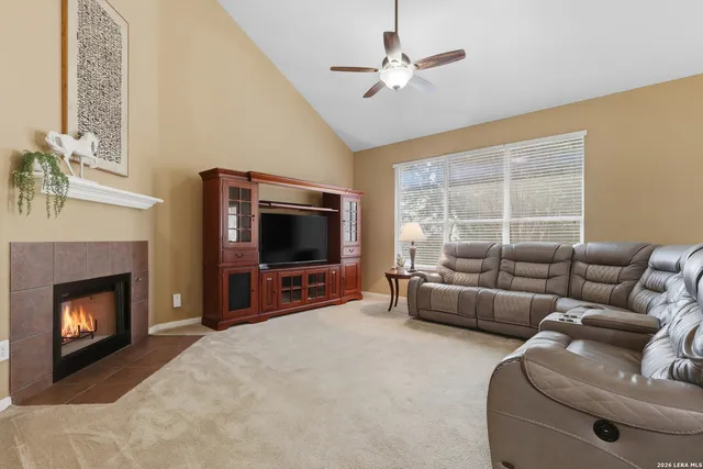 a living room with furniture a fireplace and a flat screen tv