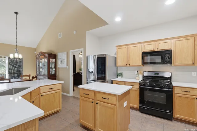 a kitchen with a sink stove and refrigerator