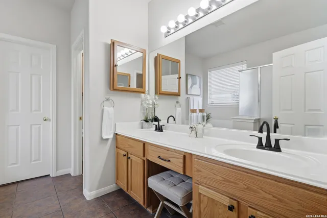 a bathroom with a sink double vanity and a mirror