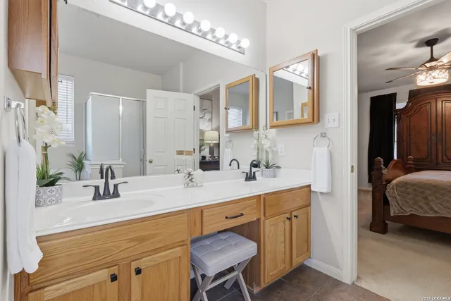a en suite bathroom with a sink double vanity and a mirror