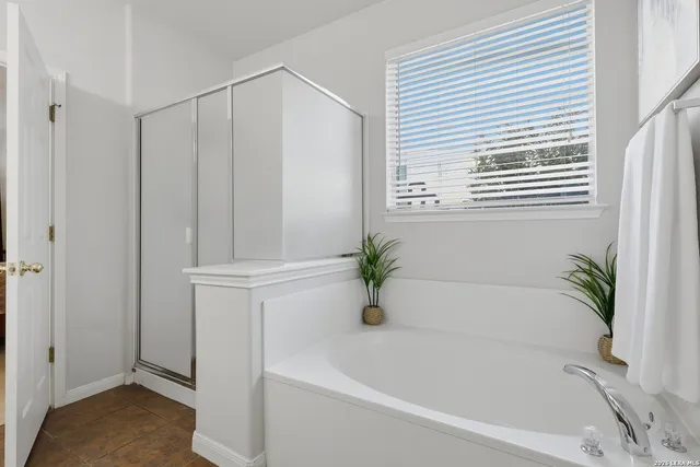 a white bath tub with a shower