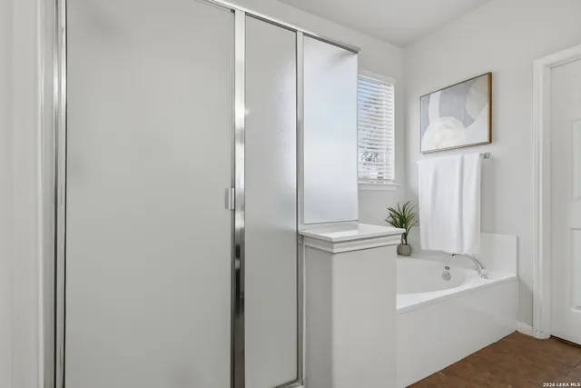 a bathroom with a bathtub and a shower