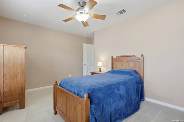 a bedroom with a bed and a ceiling fan