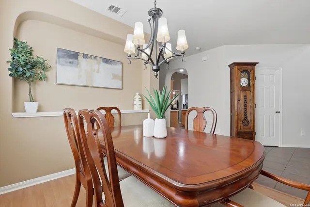 a dining room with furniture and a chandelier