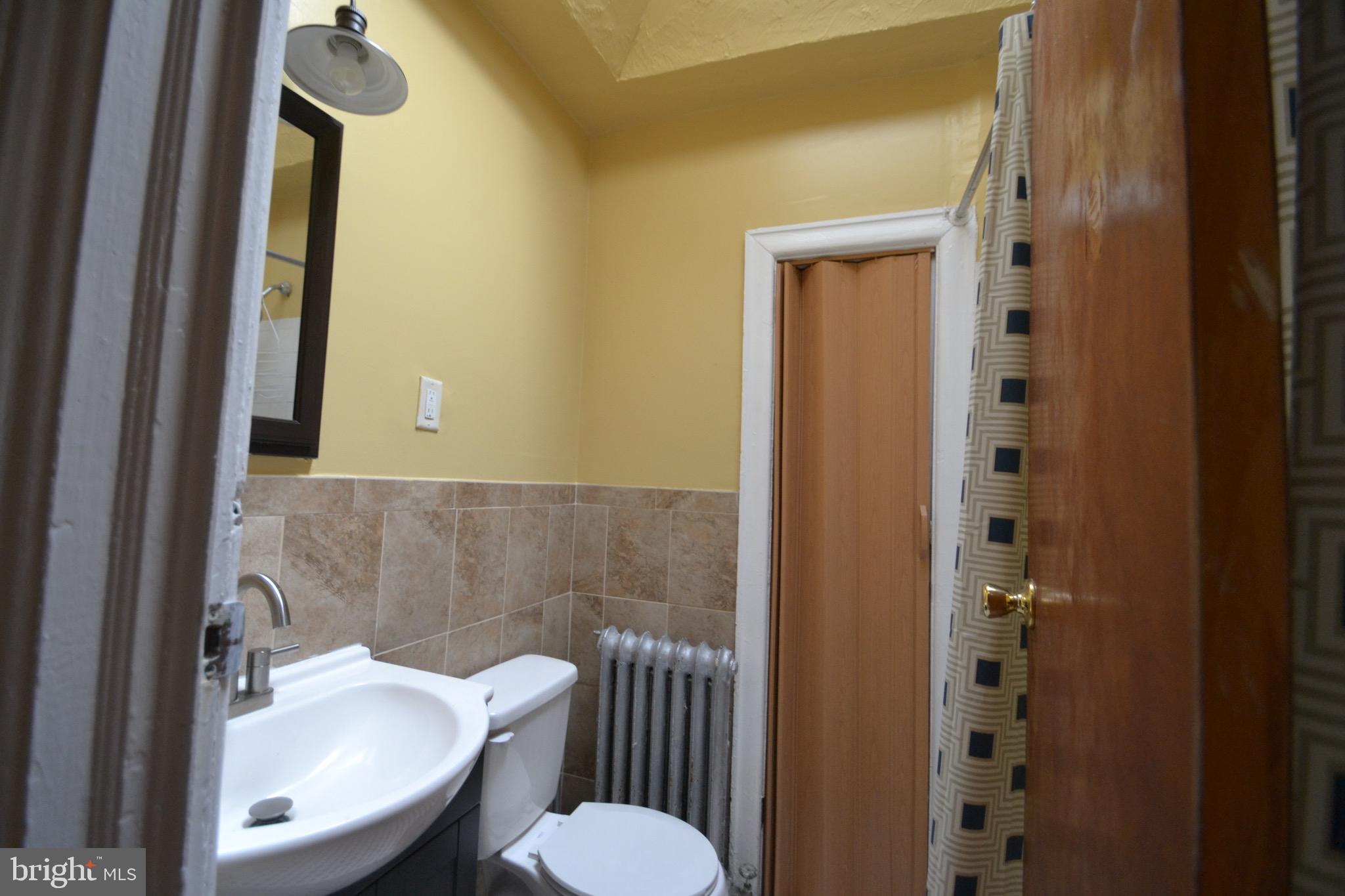 2002 North 56th Street, Unit 2 Philadelphia, PA 19131 - Photo 11 of 18 a bathroom with a sink and a mirror