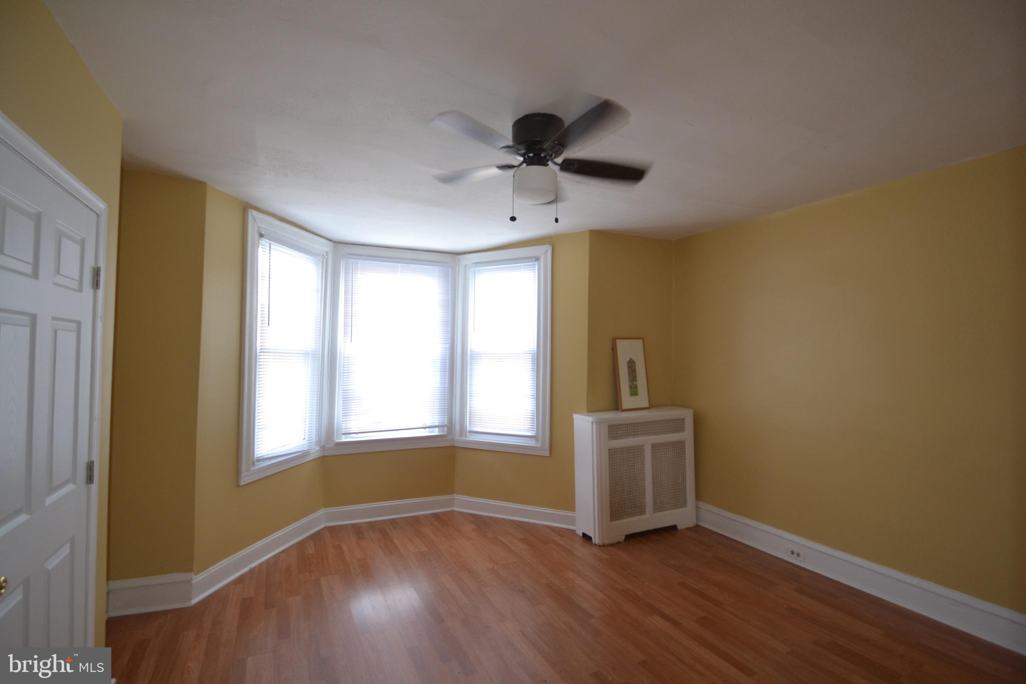 2002 North 56th Street, Unit 2 Philadelphia, PA 19131 - Photo 13 of 18 a view of an empty room with a window and wooden floor