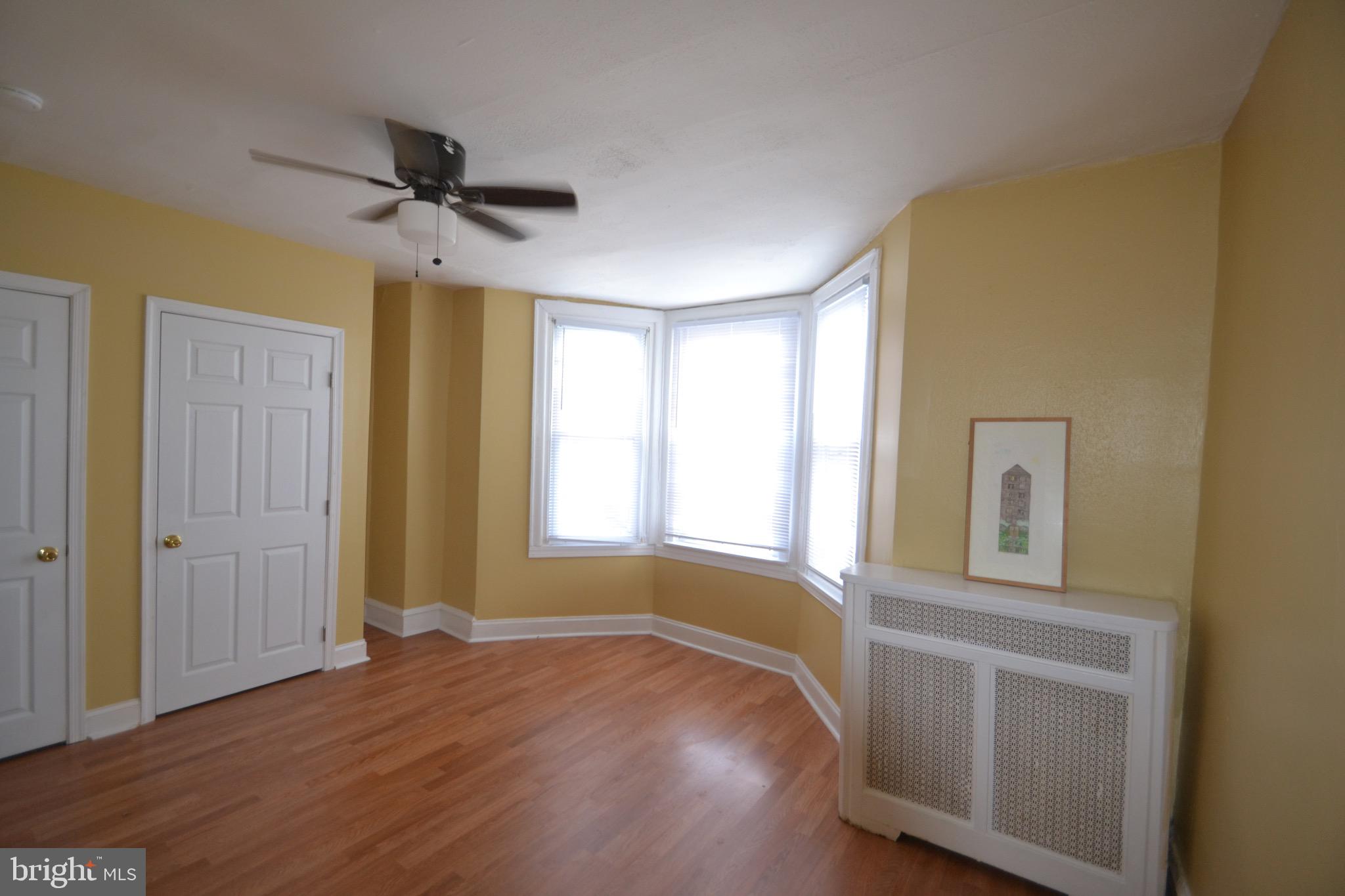 2002 North 56th Street, Unit 2 Philadelphia, PA 19131 - Photo 16 of 18 a view of an empty room with a window and wooden floor