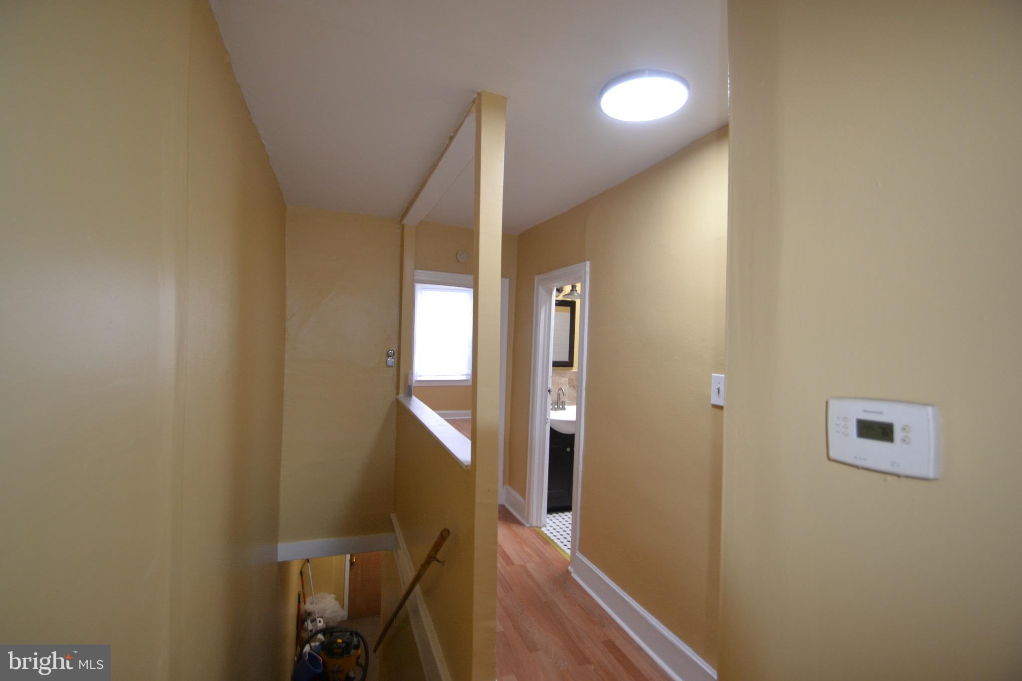 2002 North 56th Street, Unit 2 Philadelphia, PA 19131 - Photo 18 of 18 a view of a hallway with wooden floor and staircase