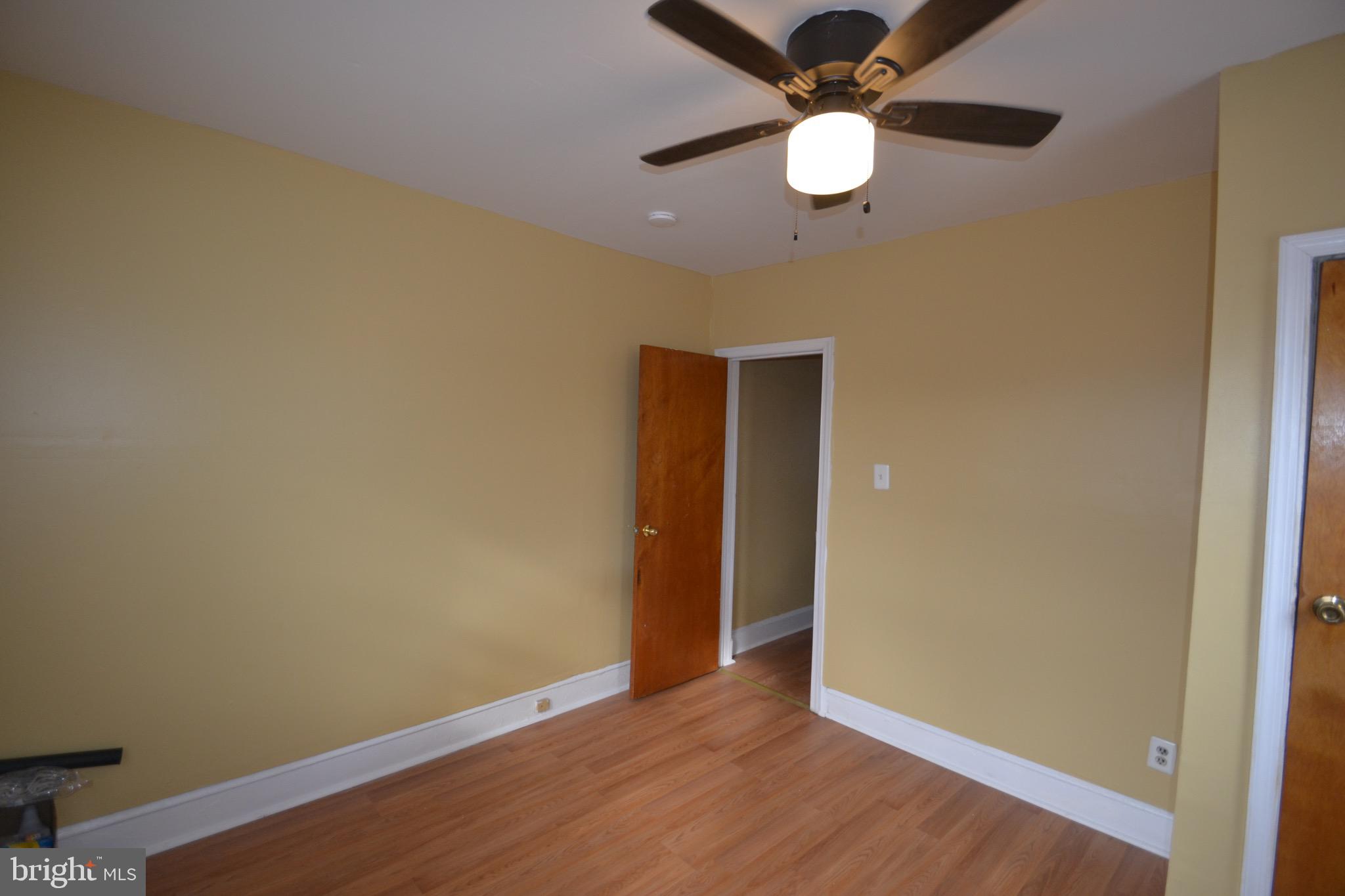 2002 North 56th Street, Unit 2 Philadelphia, PA 19131 - Photo 4 of 18 an empty room with wooden floor a ceiling fan and closet
