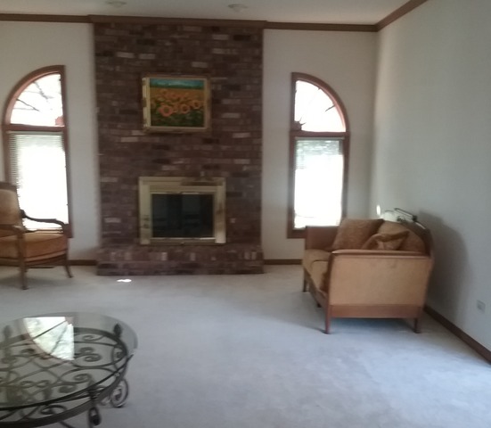 1211 Aspen Way Addison, IL 60101 - Photo 8 of 25 a living room with furniture and a fireplace