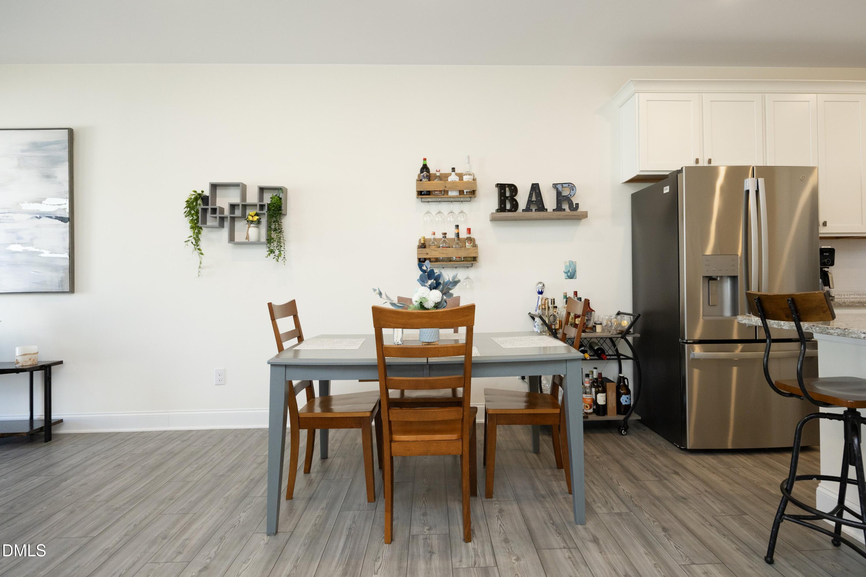 1002 Heartstone Way Durham, NC 27713 - Photo 6 of 35 a view of a dining room with furniture and wooden floor