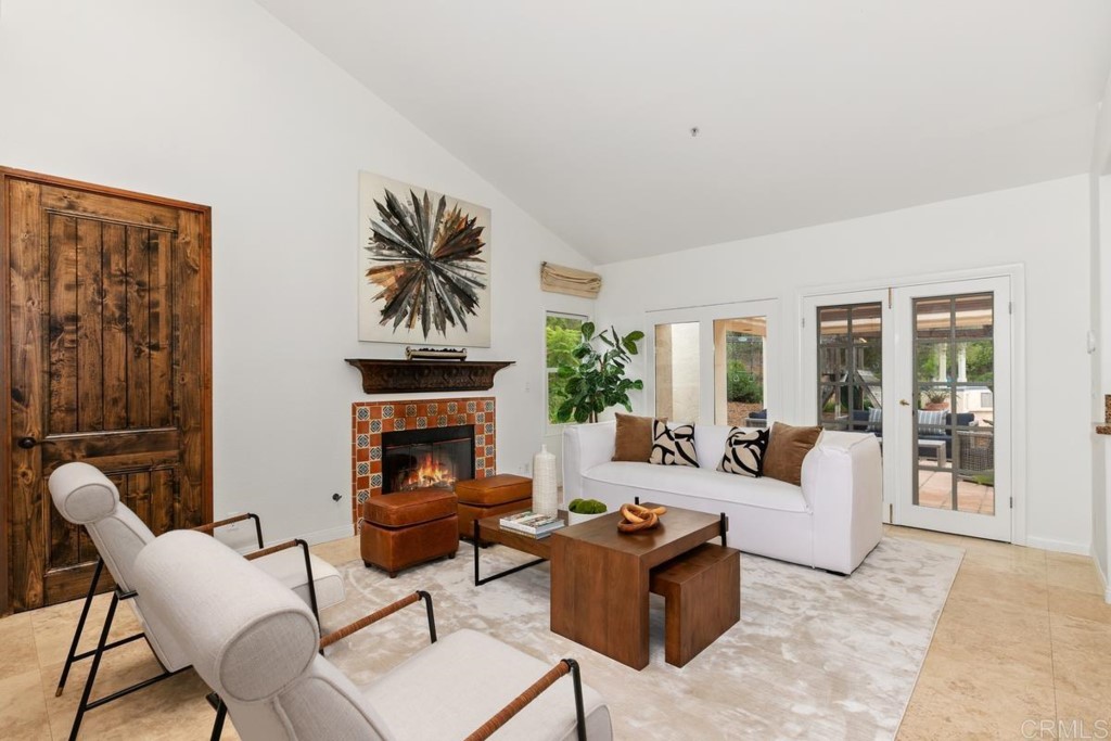 3303 Bumann Road Encinitas, CA 92024 - Photo 13 of 50 a living room with furniture a fireplace and a large window