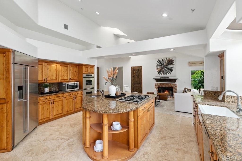 3303 Bumann Road Encinitas, CA 92024 - Photo 15 of 50 a large kitchen with stainless steel appliances granite countertop a stove and a sink