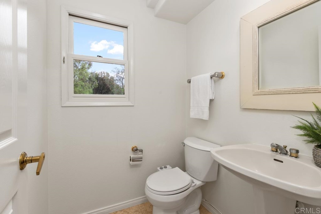 3303 Bumann Road Encinitas, CA 92024 - Photo 18 of 50 a bathroom with a toilet a sink and mirror