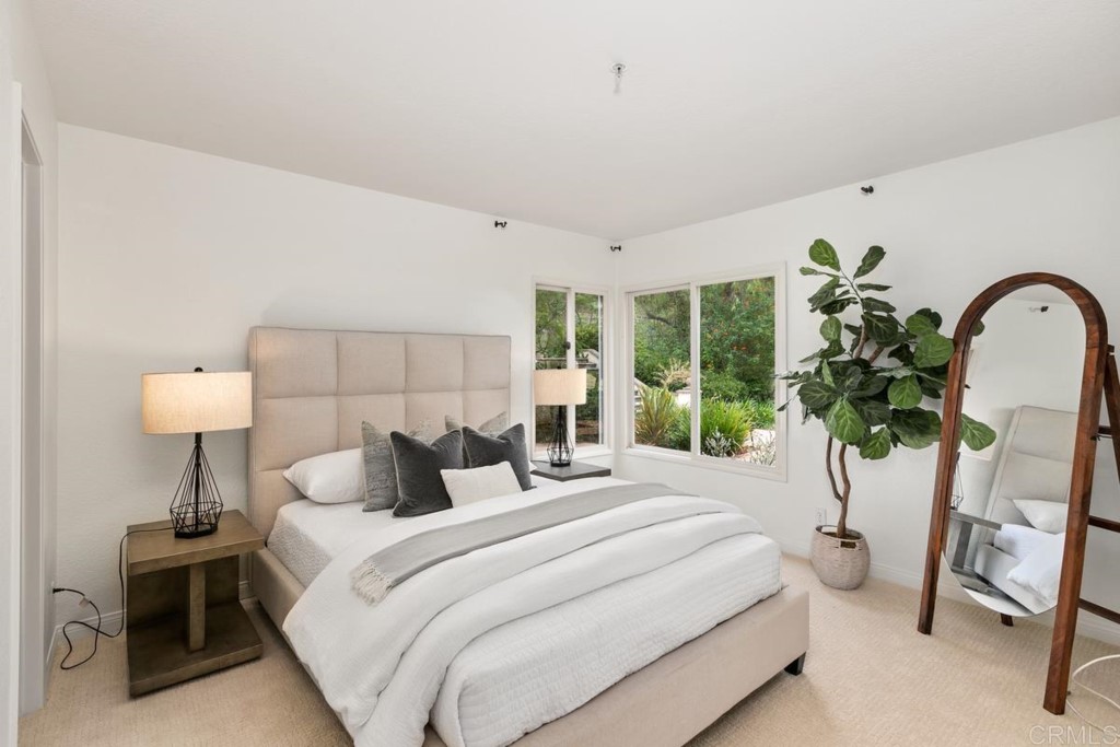 3303 Bumann Road Encinitas, CA 92024 - Photo 26 of 50 a bedroom with a bed and a potted plant