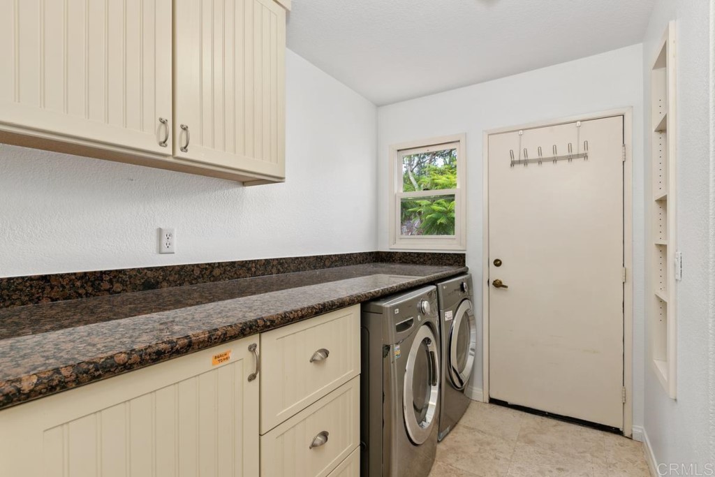 3303 Bumann Road Encinitas, CA 92024 - Photo 28 of 50 a utility room with granite countertop cabinets washer and dryer