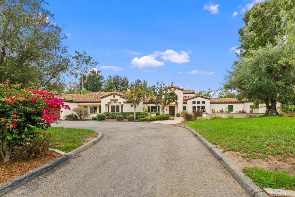 3303 Bumann Road Encinitas, CA 92024 - Photo 3 of 50 a front view of a house with a garden and trees