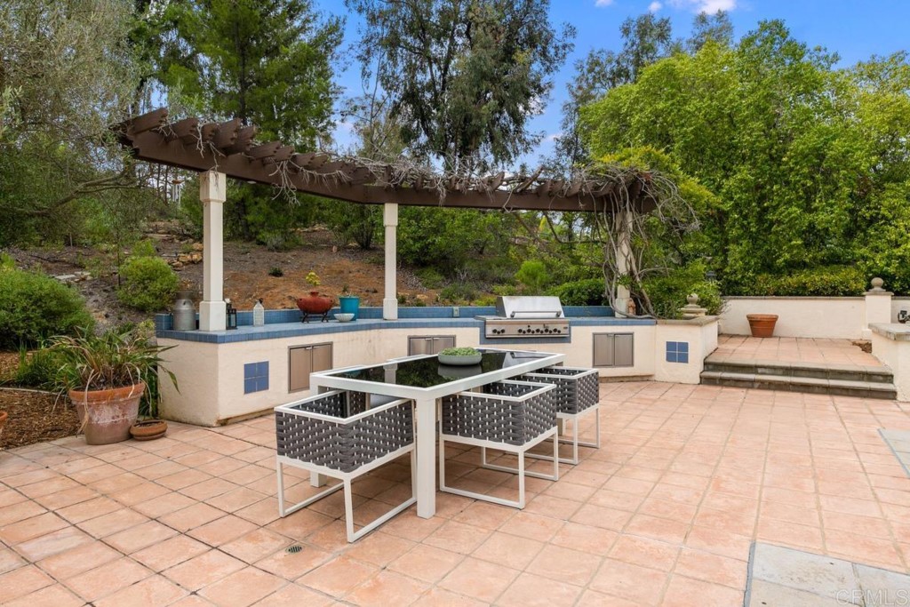 3303 Bumann Road Encinitas, CA 92024 - Photo 38 of 50 a view of a patio with a table and chairs