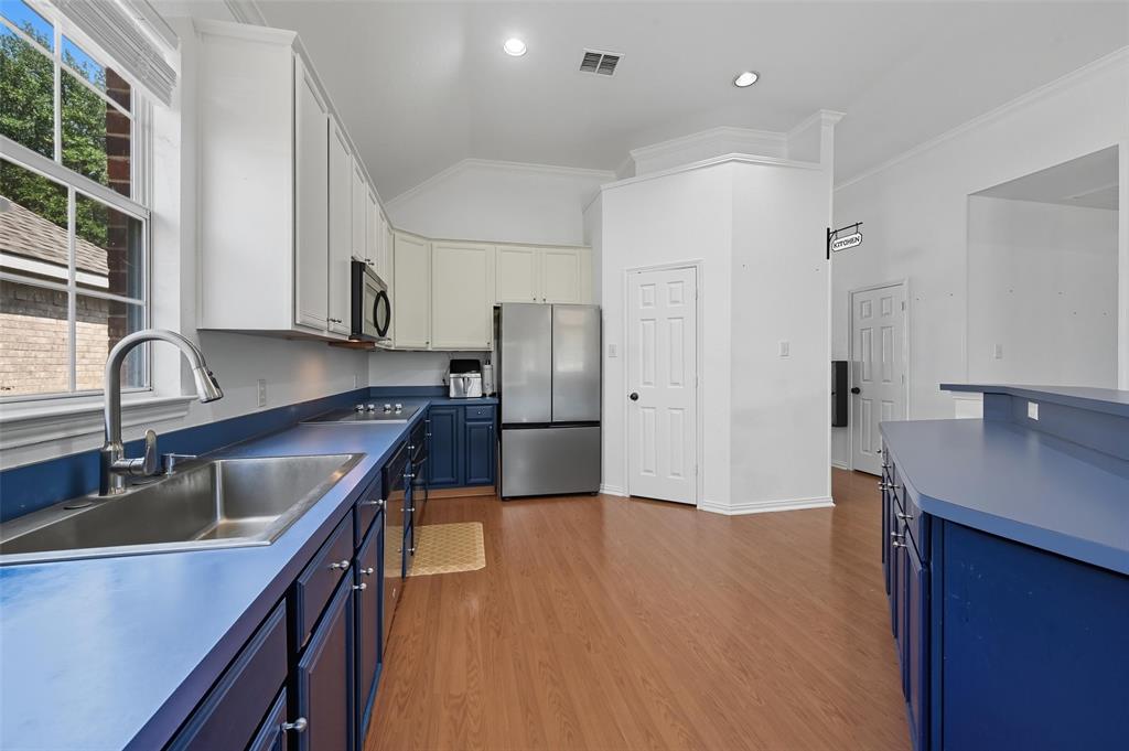 646 Huntington Lane Allen, TX 75002 - Photo 13 of 33 a kitchen with kitchen island granite countertop a sink stainless steel appliances and cabinets