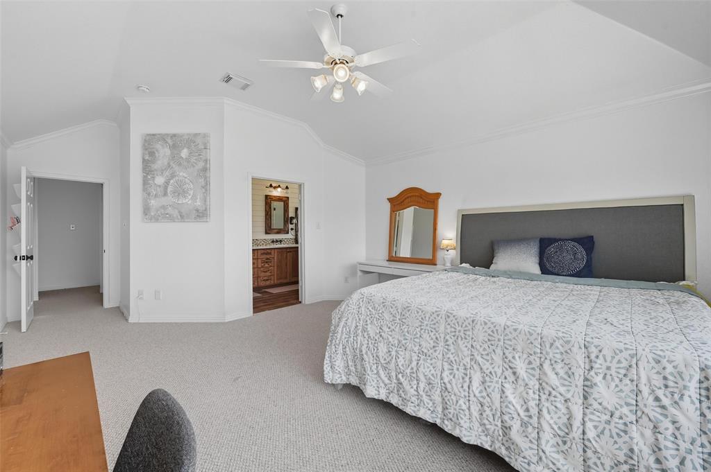 646 Huntington Lane Allen, TX 75002 - Photo 16 of 33 a bedroom with a large bed and a chandelier