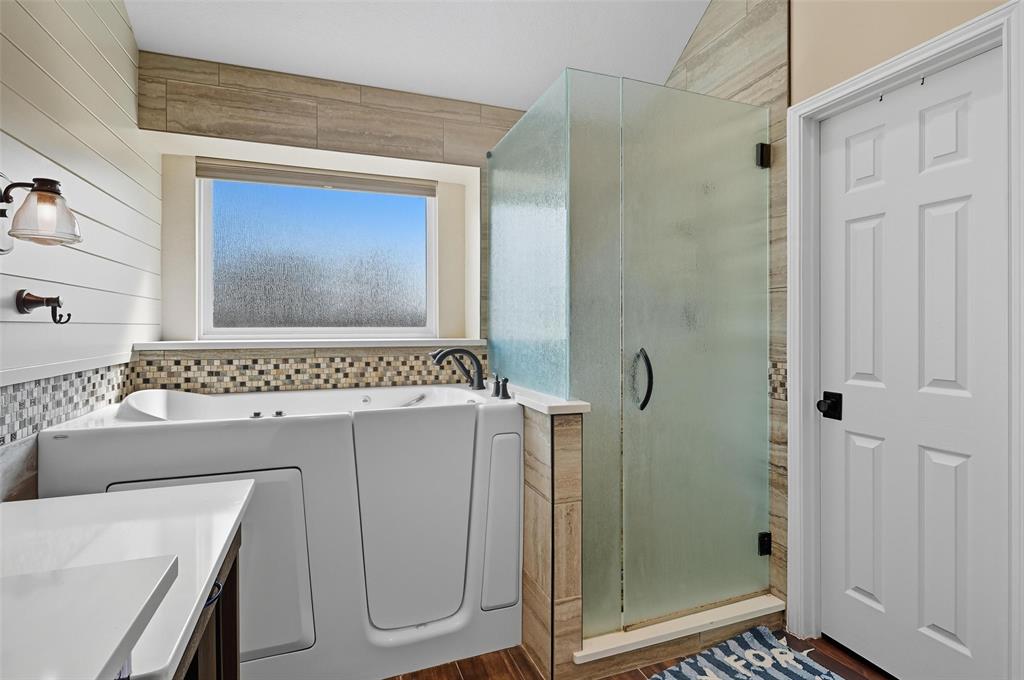 646 Huntington Lane Allen, TX 75002 - Photo 19 of 33 a bathroom with a sink a mirror and a shower