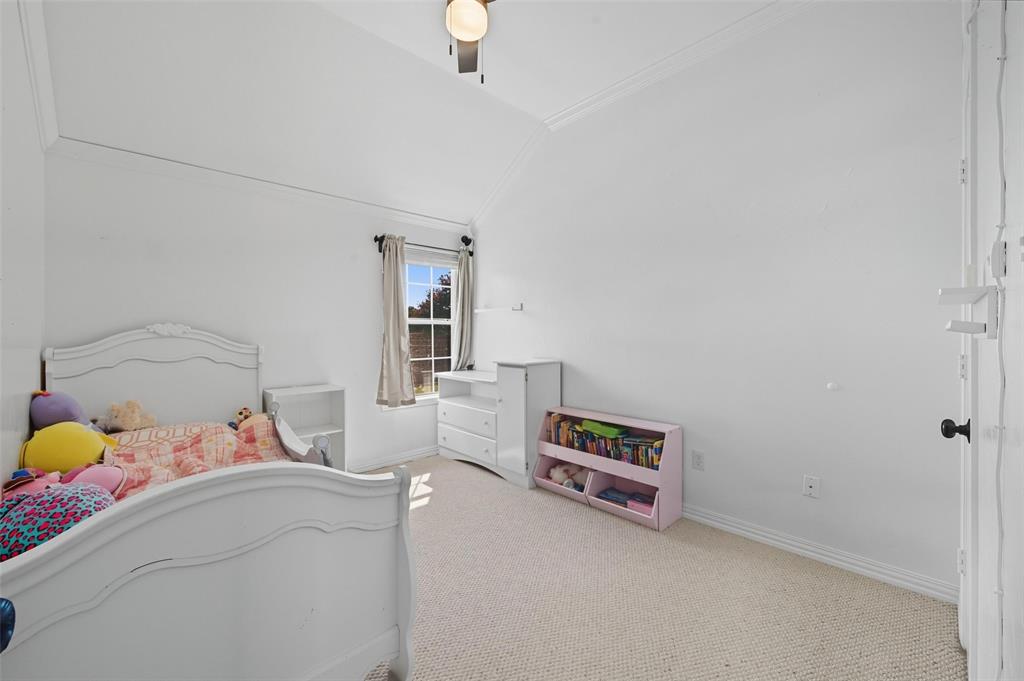 646 Huntington Lane Allen, TX 75002 - Photo 20 of 33 a room with a bed and a chandelier