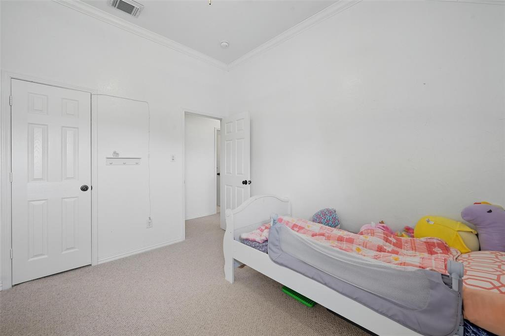 646 Huntington Lane Allen, TX 75002 - Photo 21 of 33 a bed room with a bed and a baby crib