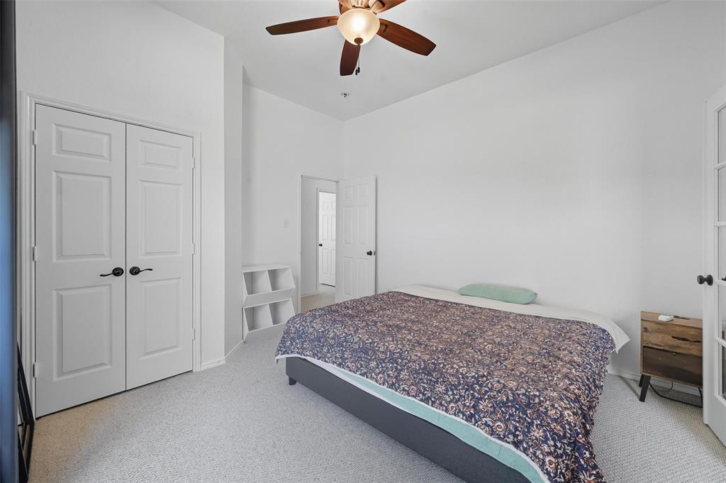 646 Huntington Lane Allen, TX 75002 - Photo 7 of 33 a bedroom with a large bed and a chandelier