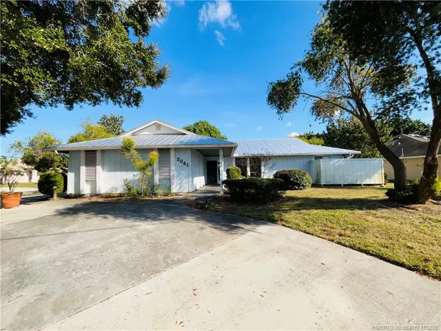 a front view of a house with a garden and porch