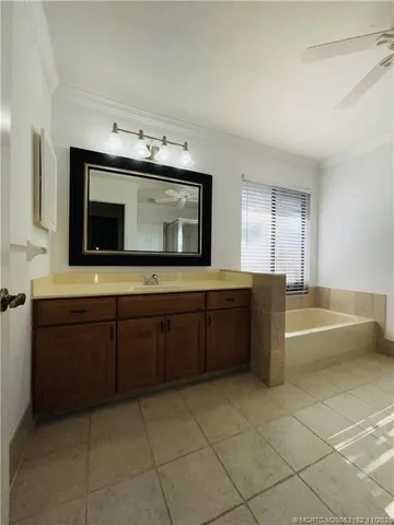 a bathroom with a bathtub sink and mirror