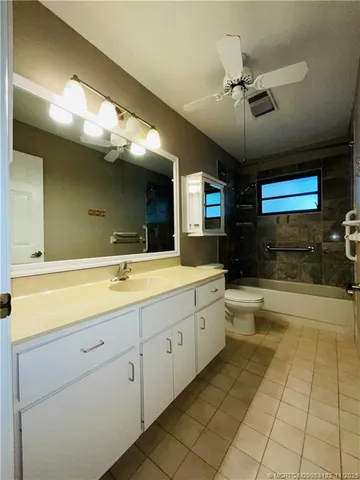 a bathroom with a double vanity sink a mirror and a bathtub