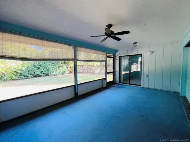 a view of room with window and ceiling fan