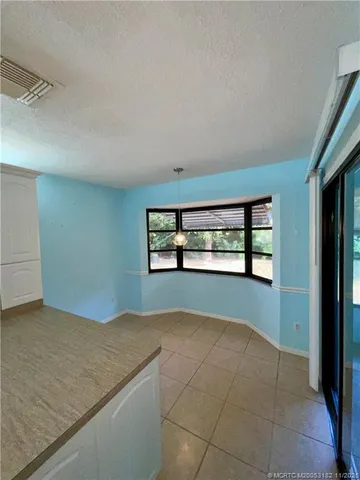 an empty room with large windows