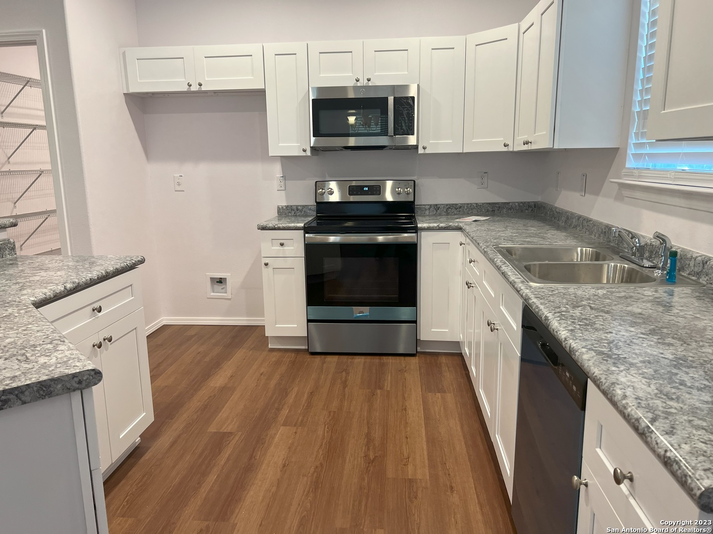 141 Wright Cove Cibolo, TX 78108 - Photo 12 of 35 a kitchen with granite countertop a sink and a stove top oven