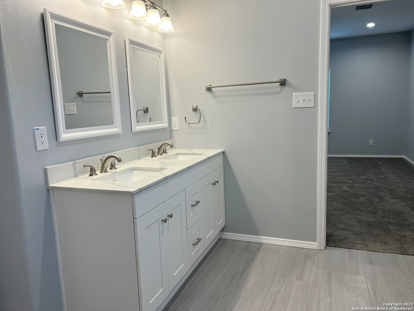 141 Wright Cove Cibolo, TX 78108 - Photo 21 of 35 a bathroom with a double vanity sink and mirror