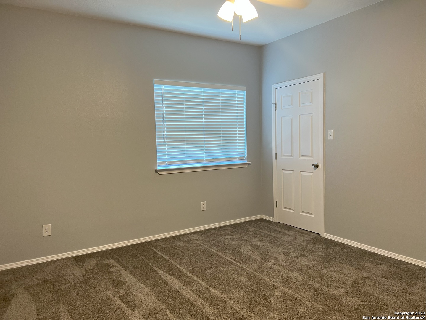 141 Wright Cove Cibolo, TX 78108 - Photo 29 of 35 an empty room with a chandelier fan and windows