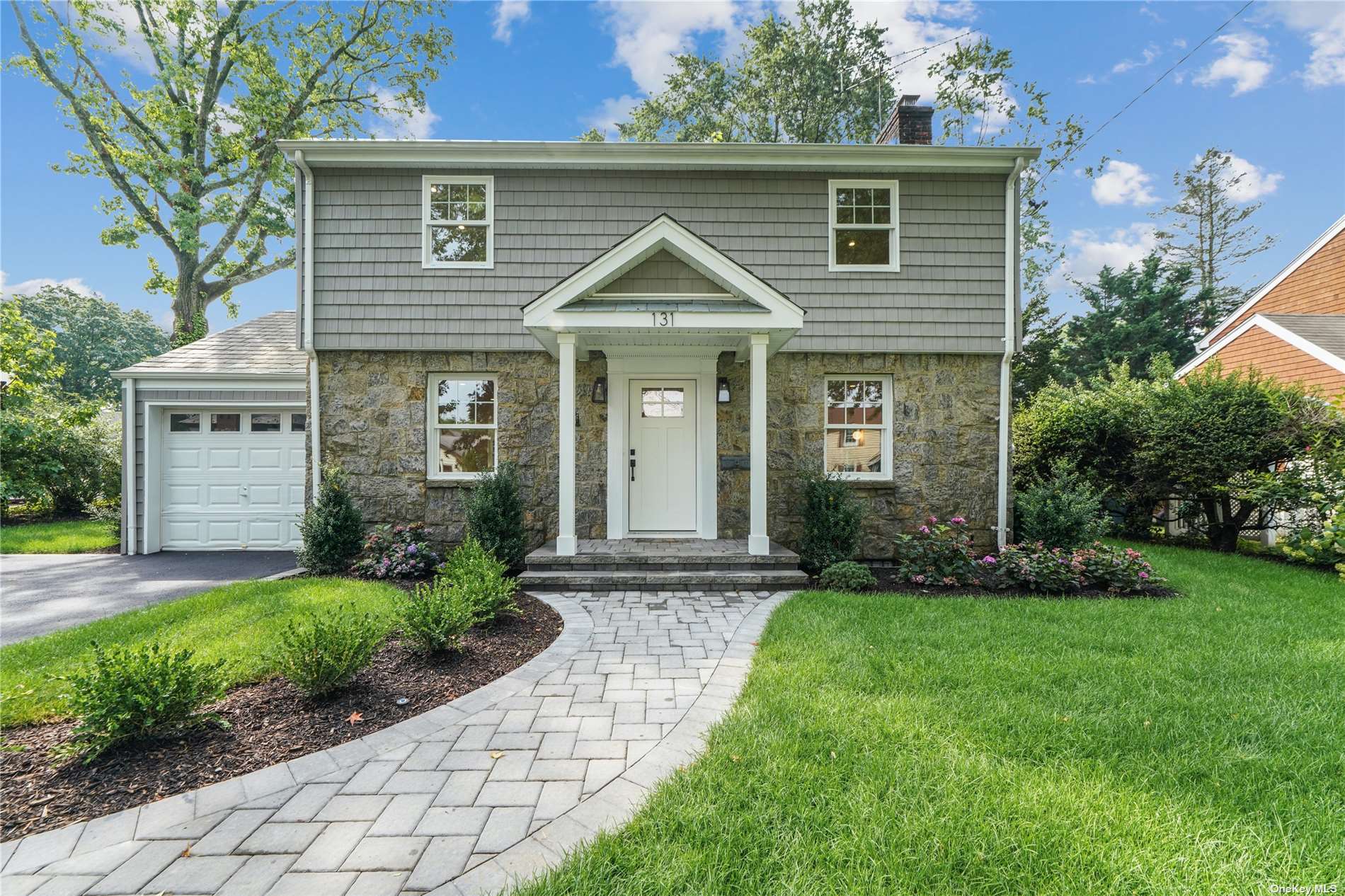131 Charles Street Williston Park, NY 11596 - Photo 1 of 1 a view of brick house with a yard and plants