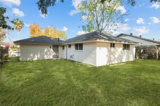 a front view of house with yard and trees