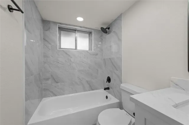 a bathroom with a toilet and a bathtub