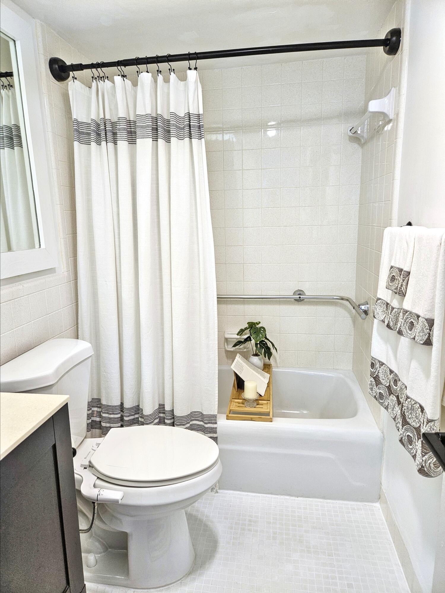 6530 North Ocean Boulevard, Unit 205 Ocean Ridge, FL 33435 - Photo 25 of 53 a bathroom with a sink a toilet and a bathtub