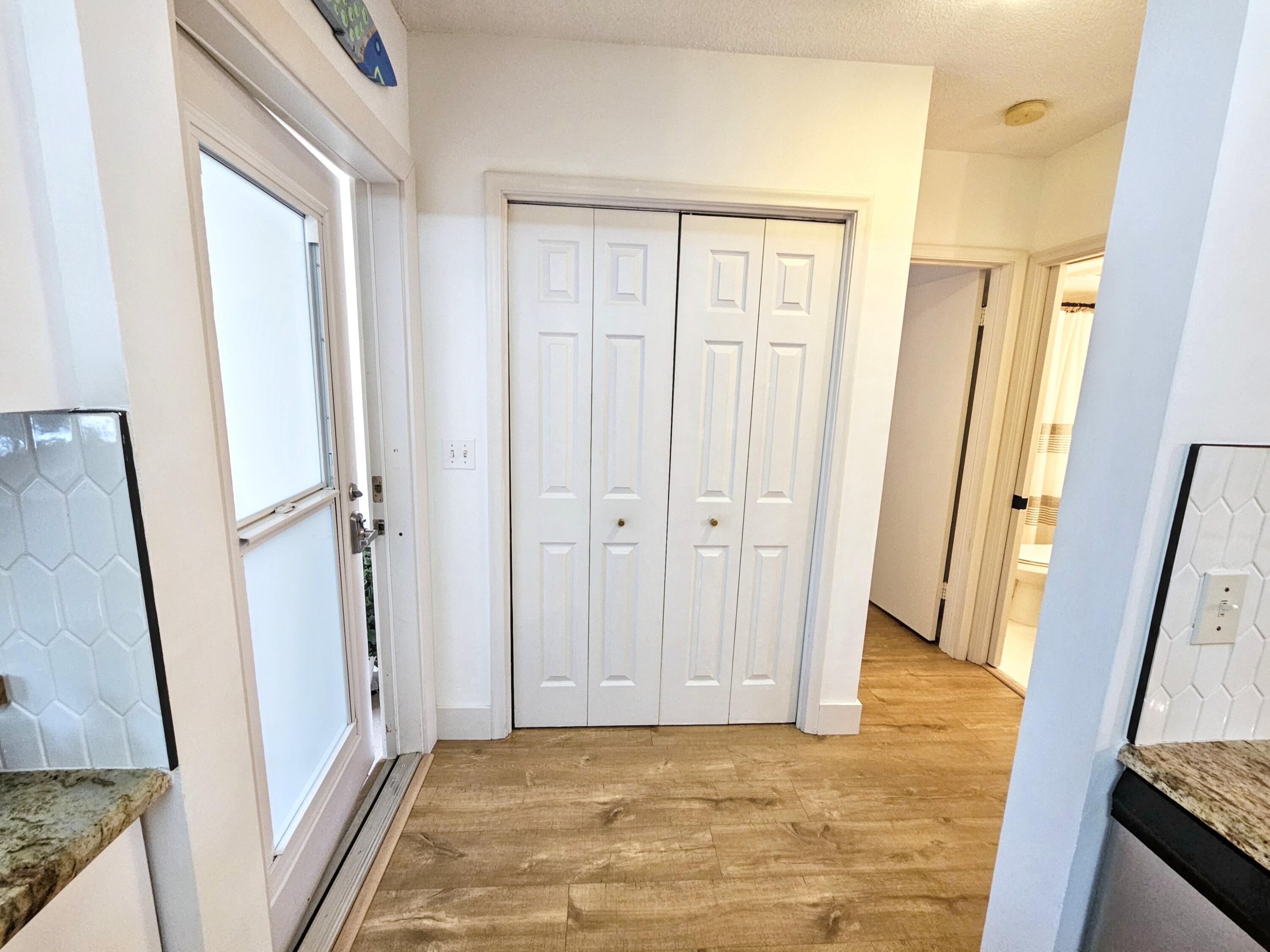 6530 North Ocean Boulevard, Unit 205 Ocean Ridge, FL 33435 - Photo 33 of 53 a view of a hallway with wooden floor and staircase