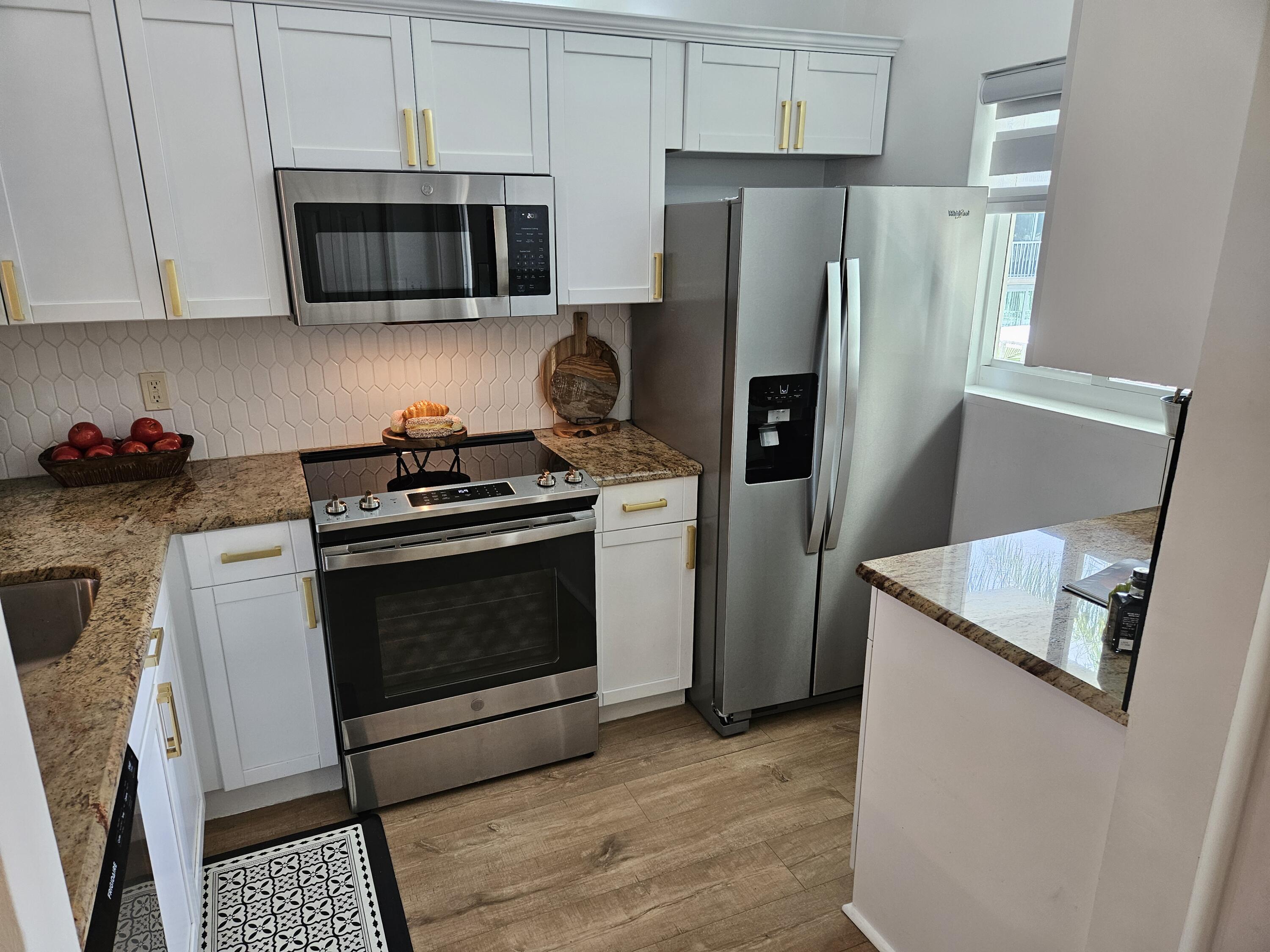 6530 North Ocean Boulevard, Unit 205 Ocean Ridge, FL 33435 - Photo 7 of 53 a kitchen with a stove microwave and refrigerator