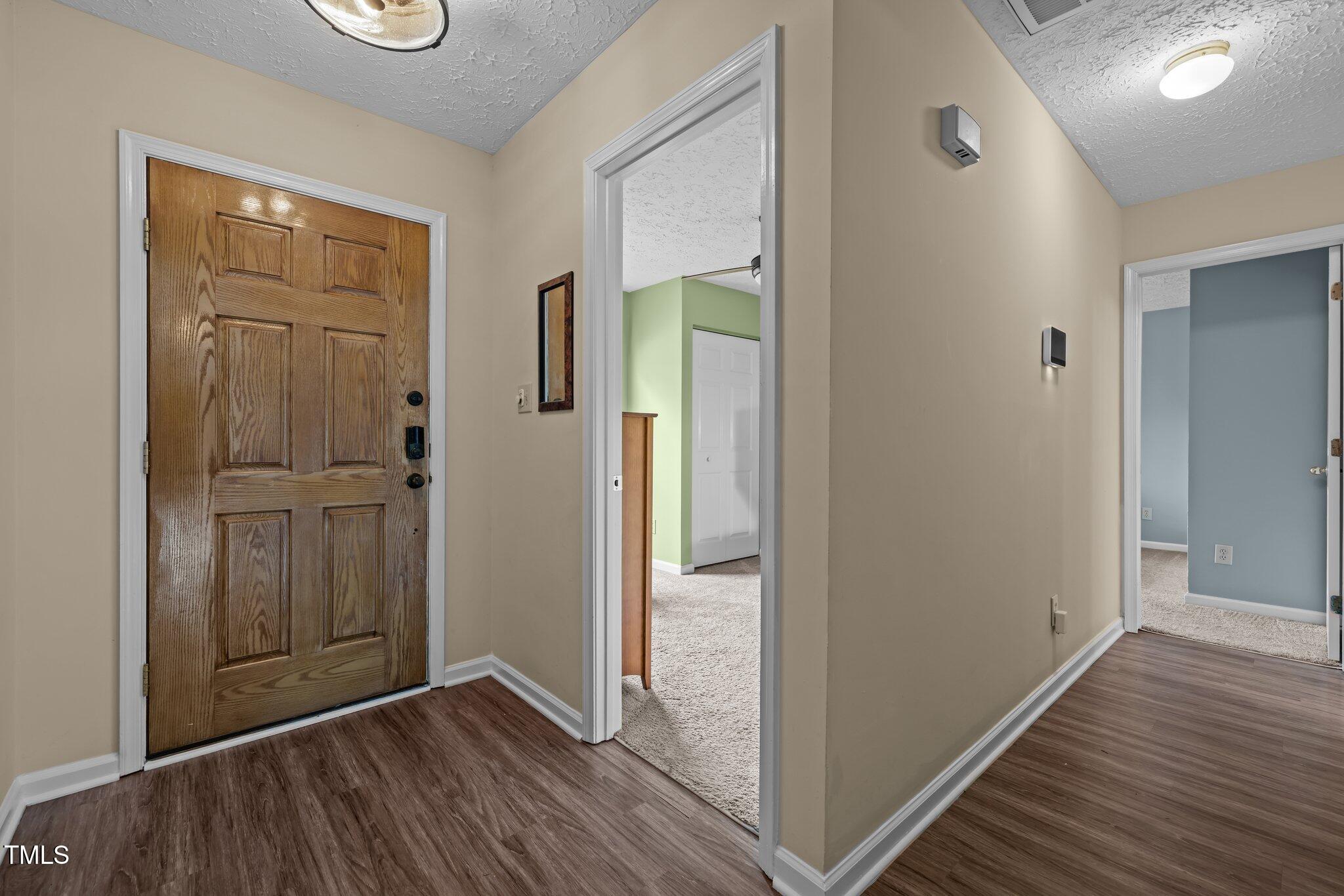 5801 Hadrian Drive Durham, NC 27703 - Photo 14 of 40 an empty room with wooden floor & closet area