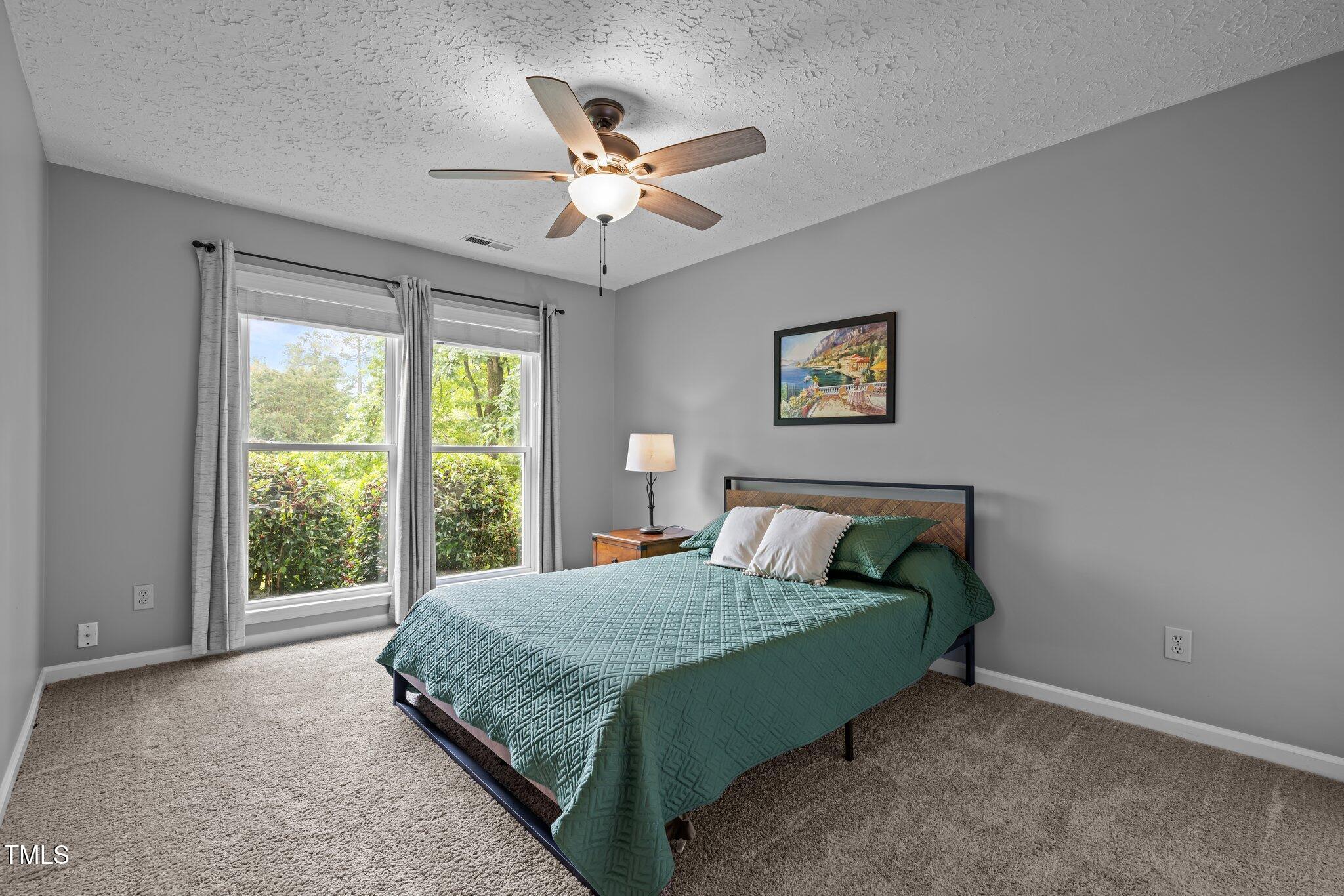 5801 Hadrian Drive Durham, NC 27703 - Photo 18 of 40 a bedroom with a bed and window