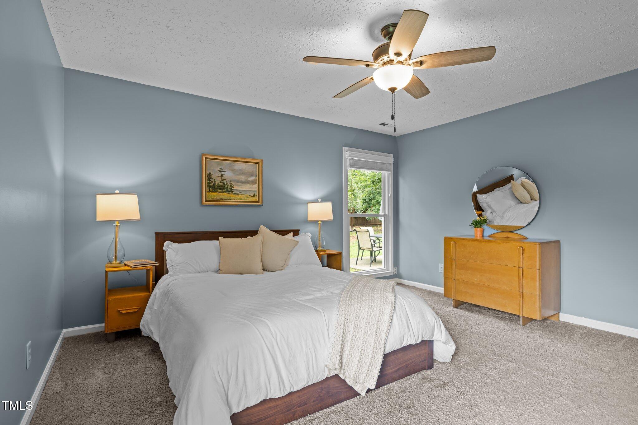 5801 Hadrian Drive Durham, NC 27703 - Photo 22 of 40 a bedroom with a bed and a chandelier