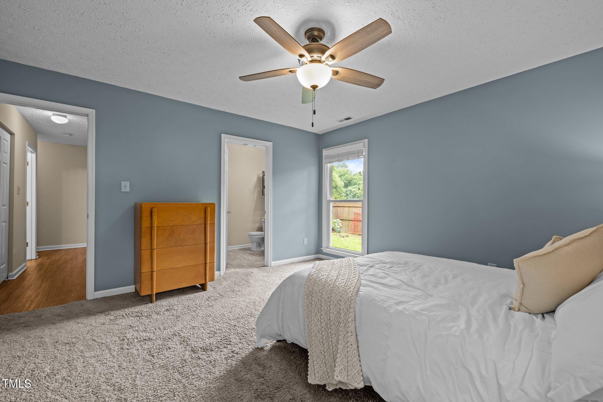 5801 Hadrian Drive Durham, NC 27703 - Photo 23 of 40 a bedroom with a bed and window