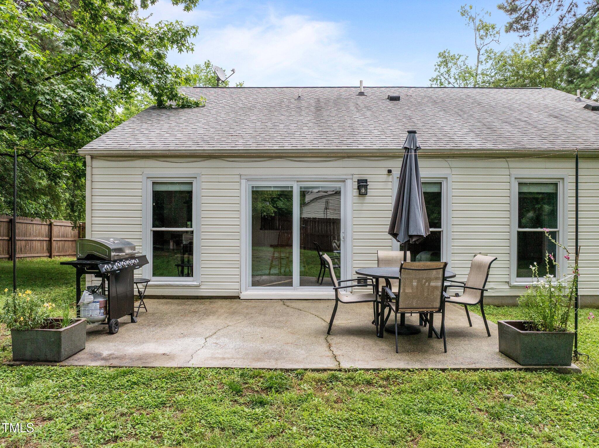 5801 Hadrian Drive Durham, NC 27703 - Photo 29 of 40 a patio with table and chairs and potted plants