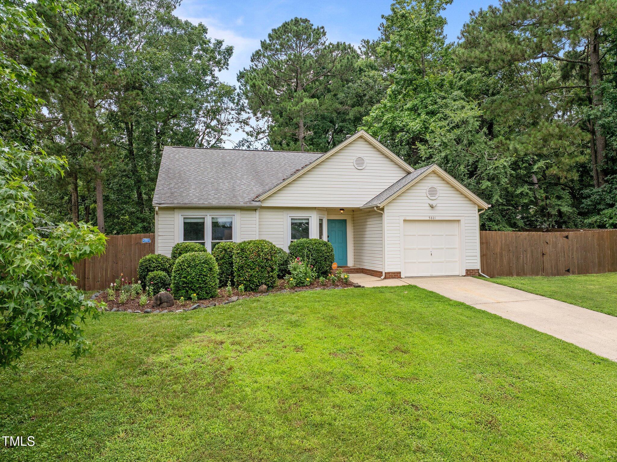 5801 Hadrian Drive Durham, NC 27703 - Photo 39 of 40 a front view of a house with a yard